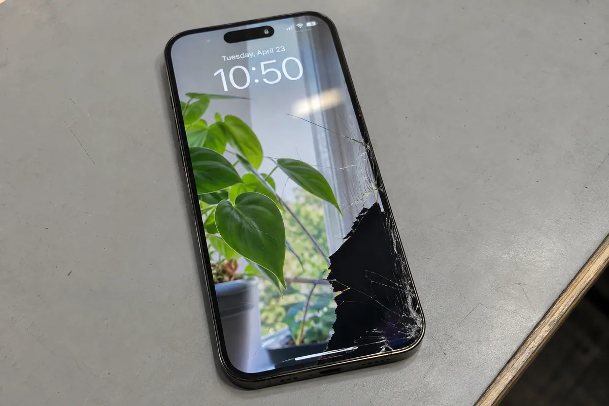 iPhone 14 Pro Max with cracked front glass and a damaged display area