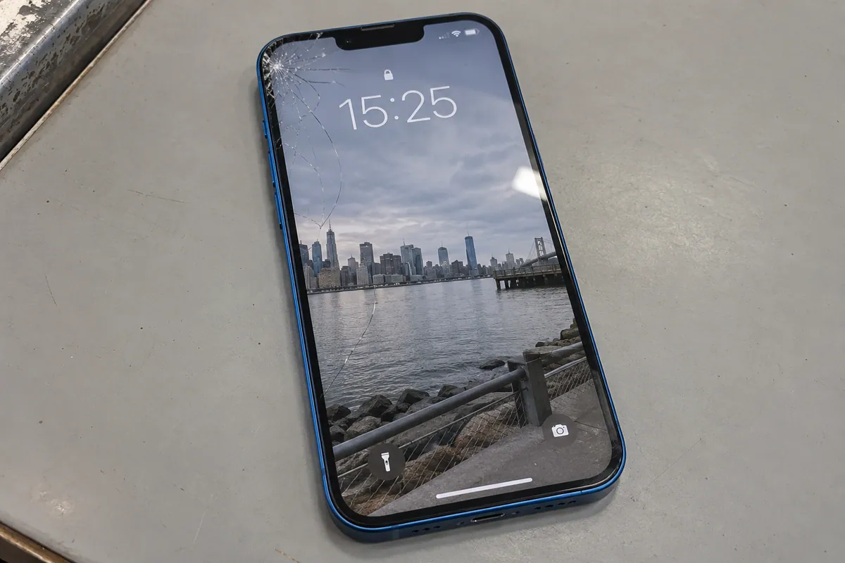 iPhone 14 showing glass damage before a general repair assessment