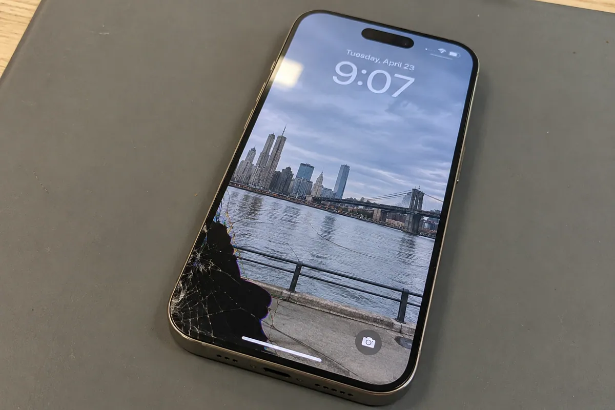 iPhone 15 Pro with cracked front glass and a damaged display area